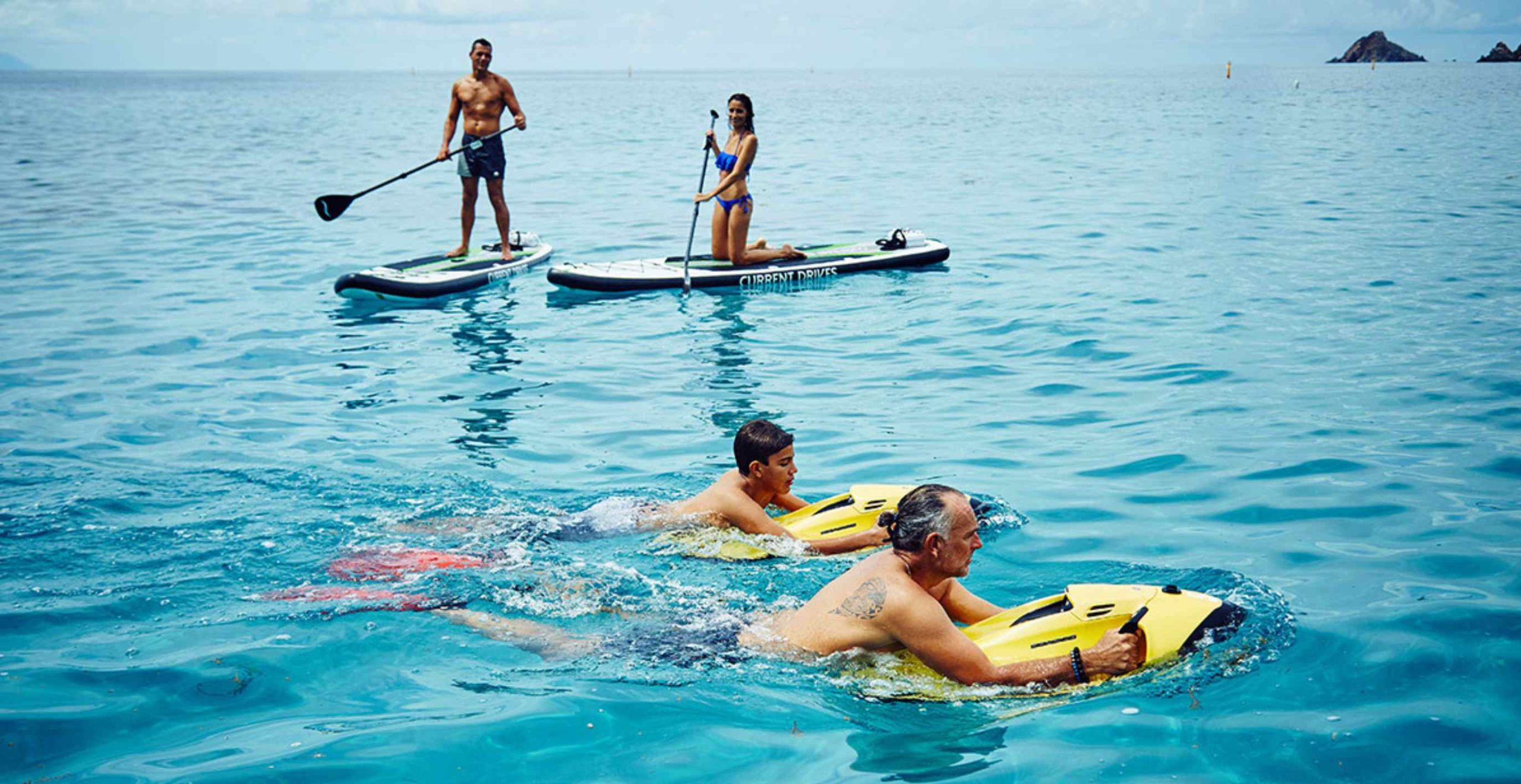 Stand-up paddling along the coast at sunrise