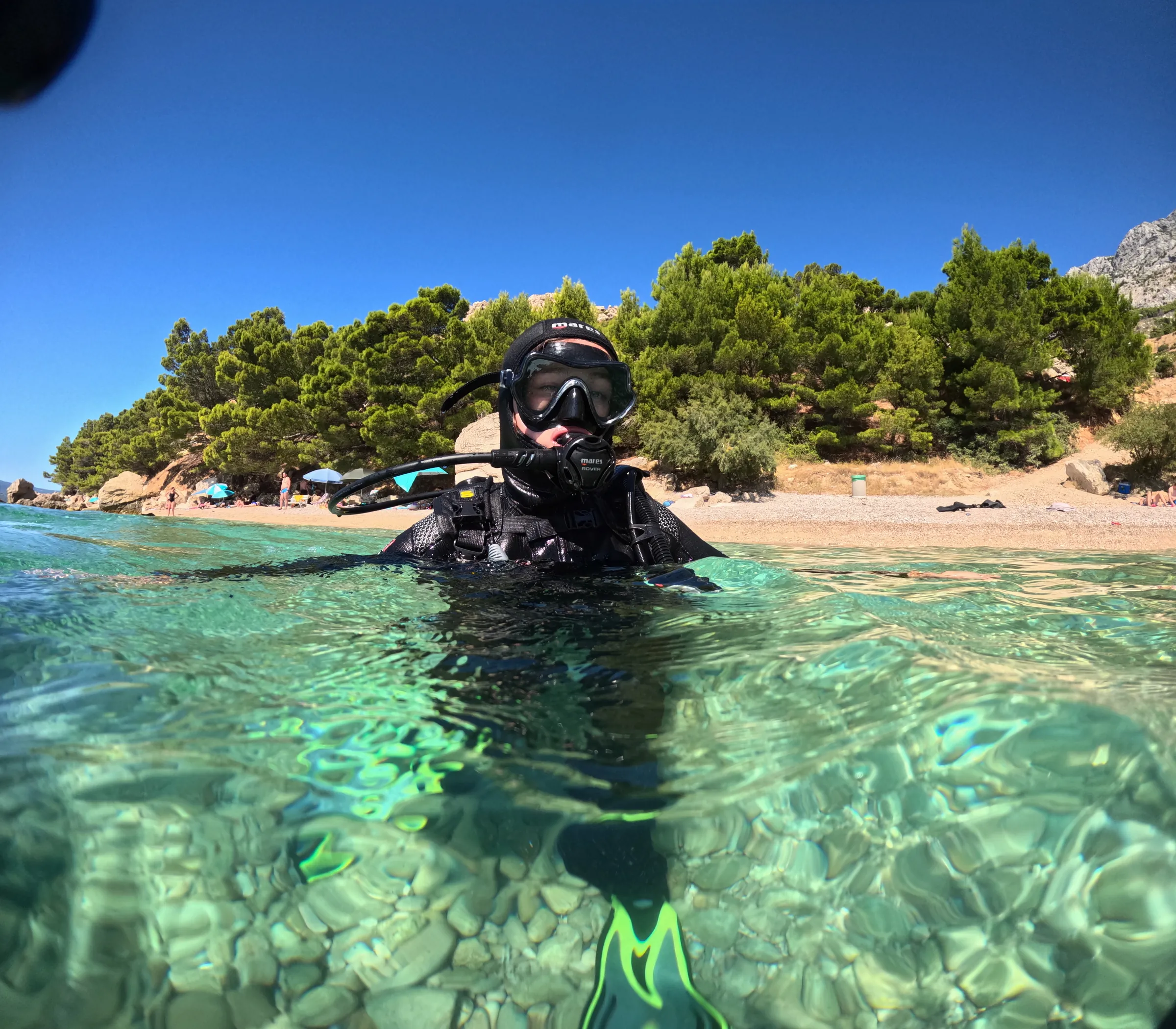 Happy divers in crystal-clear water near Omis