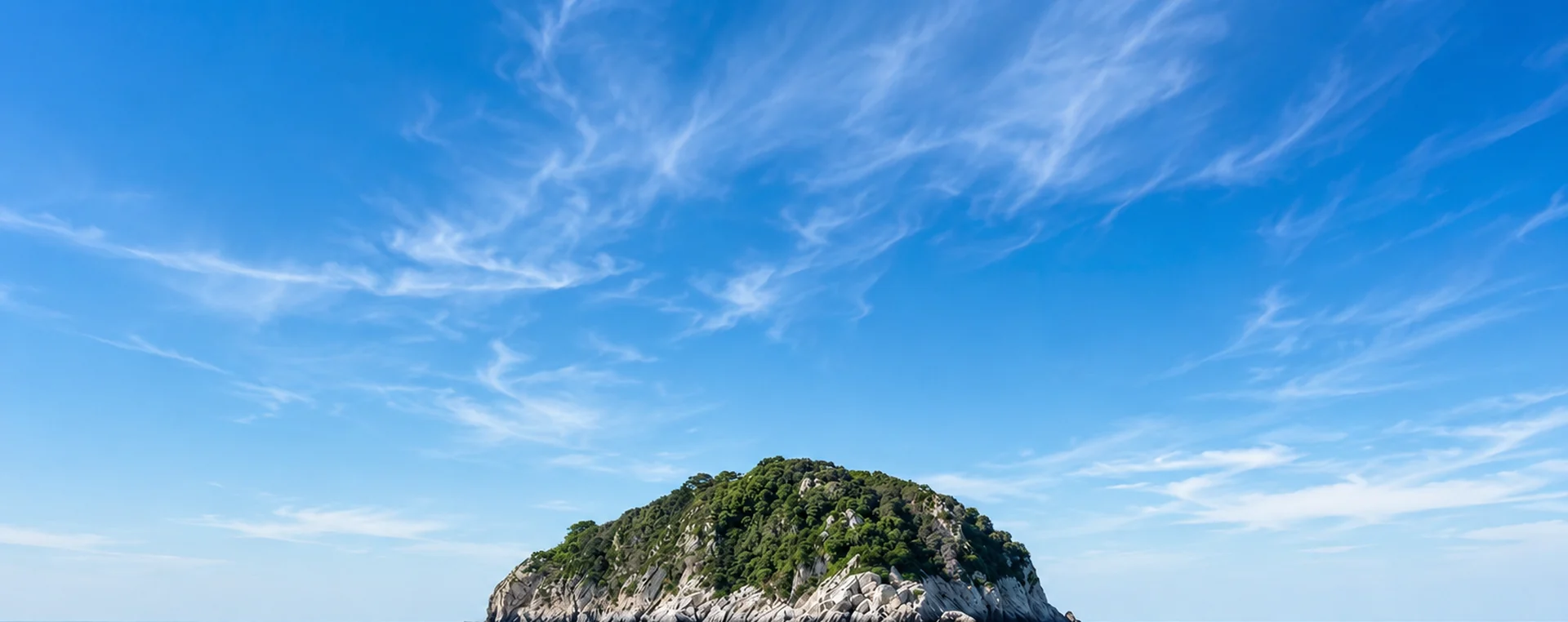 Rocky island in the calm blue Adriatic Sea near Split