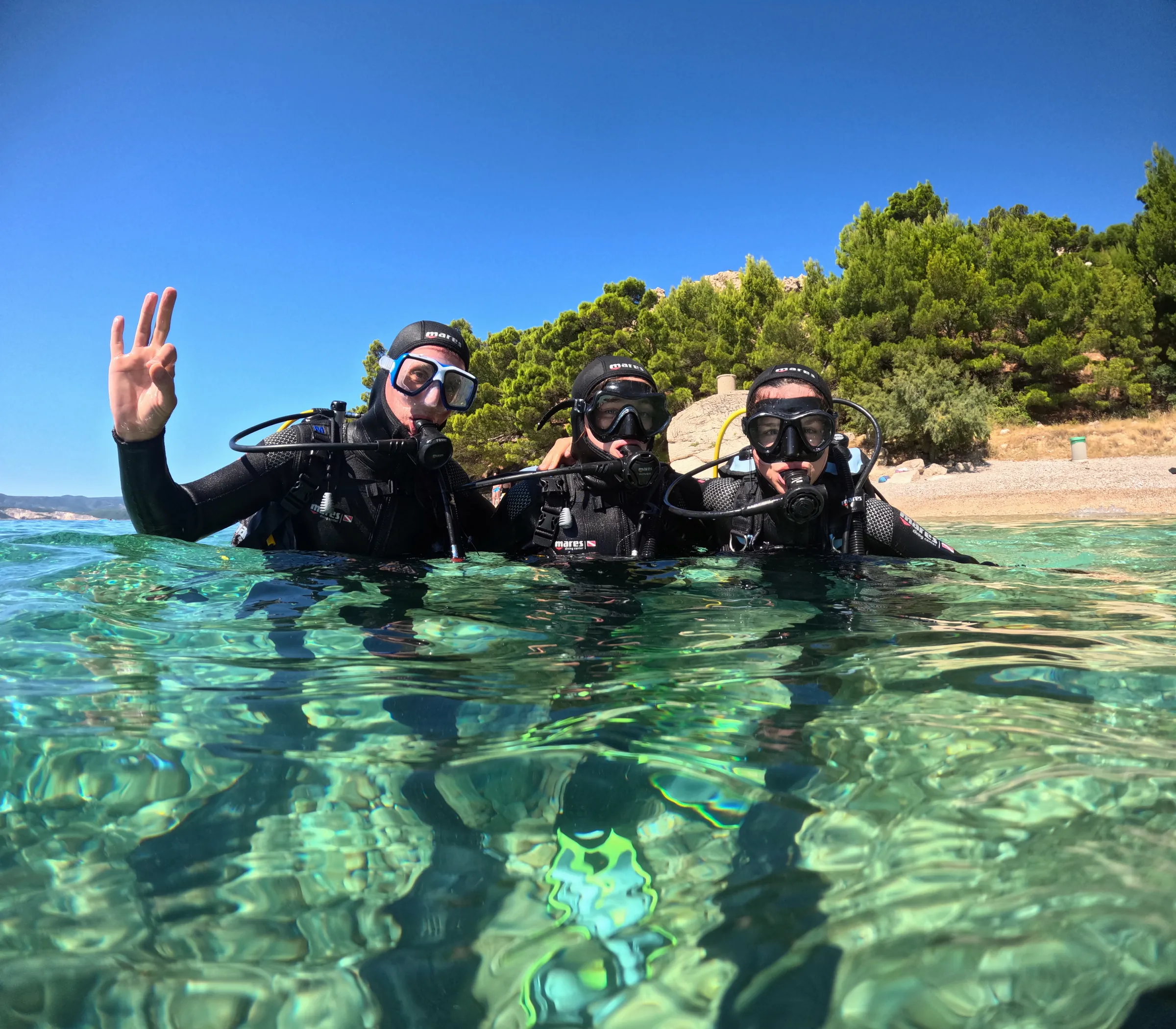 Small group of divers with the Omis coastline behind